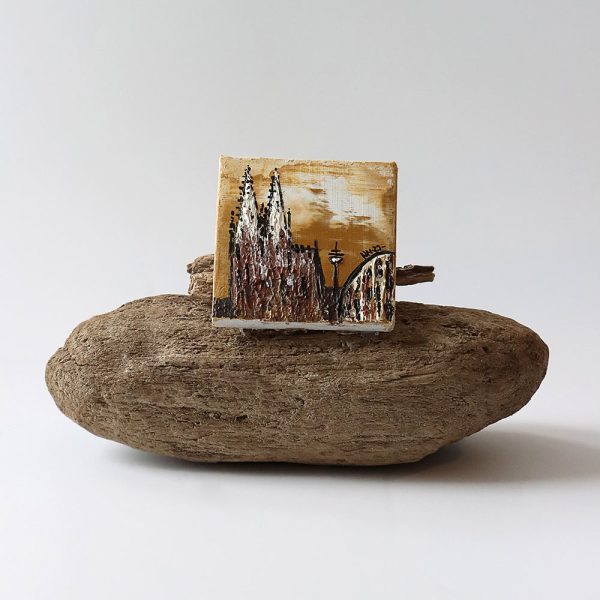 Ein Ölbild vom Kölner Dom, auf einem Stück Treibholz.